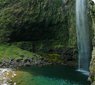 Waterfall spilling into a pool at the end of Hanakapi'ai trail